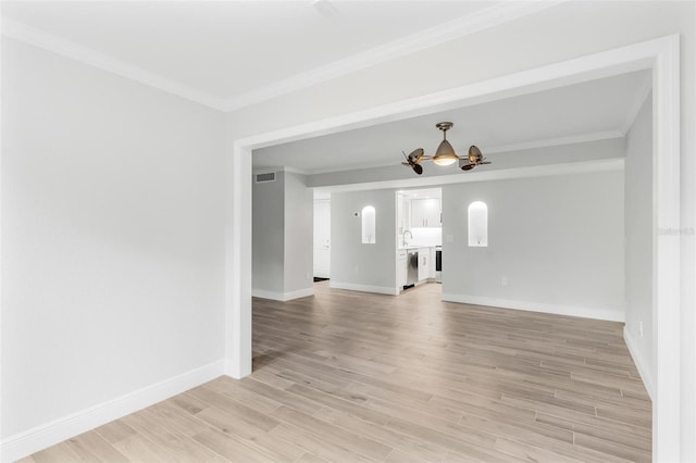 empty room featuring light hardwood / wood-style floors, ornamental molding, and sink