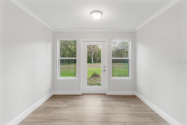 doorway to outside featuring crown molding and light wood-type flooring