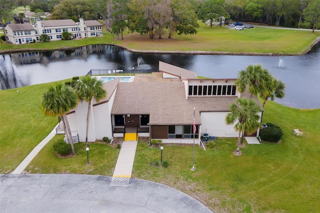 birds eye view of property with a water view