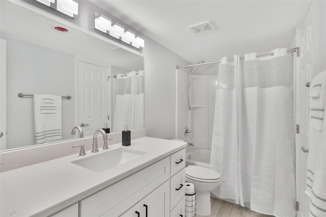 full bathroom with toilet, hardwood / wood-style flooring, vanity, and shower / bath combination with curtain