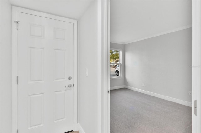 interior space featuring ornamental molding and light carpet