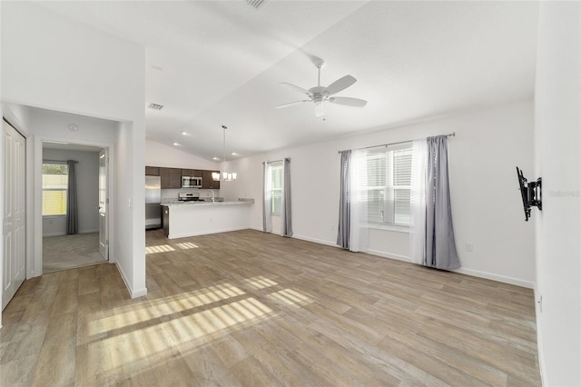 unfurnished living room with ceiling fan, light hardwood / wood-style floors, and lofted ceiling