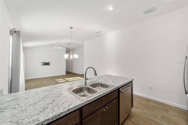 kitchen with pendant lighting, dishwasher, light wood-type flooring, and sink