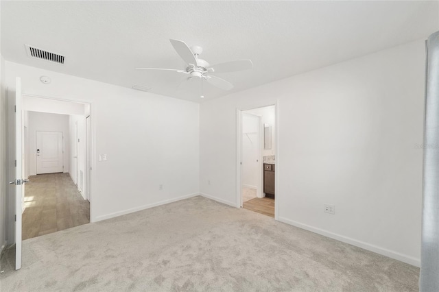 unfurnished room featuring light colored carpet and ceiling fan