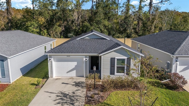 view of front of house with a garage and a front lawn