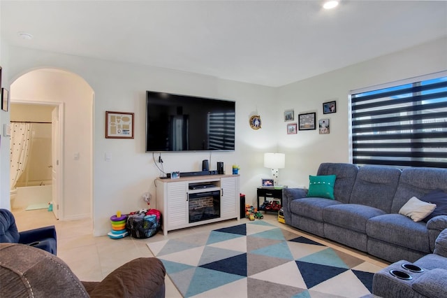 tiled living room featuring a fireplace