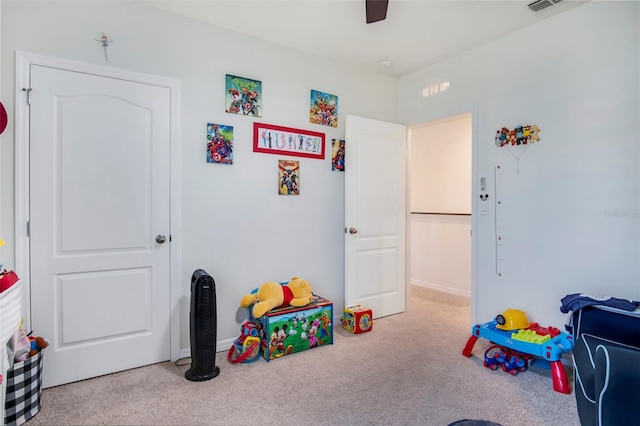 playroom featuring light carpet and ceiling fan