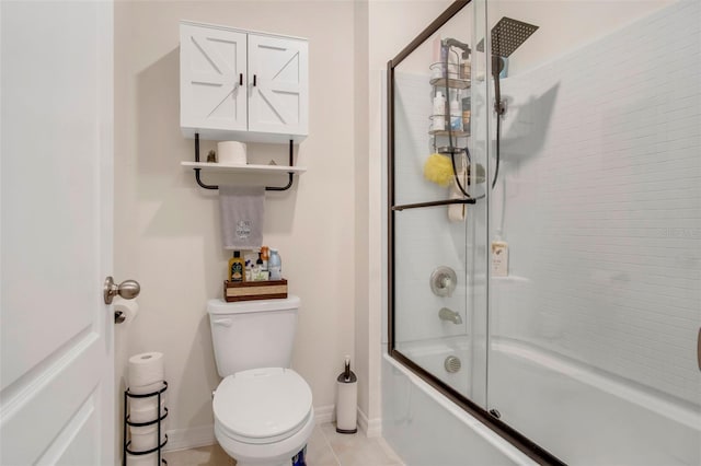 bathroom featuring enclosed tub / shower combo, tile patterned floors, and toilet