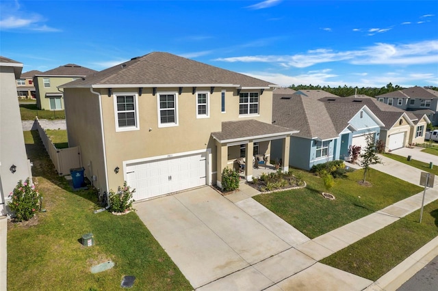 view of front of house featuring a porch, a garage, and a front lawn