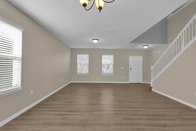 interior space with a chandelier and wood-type flooring