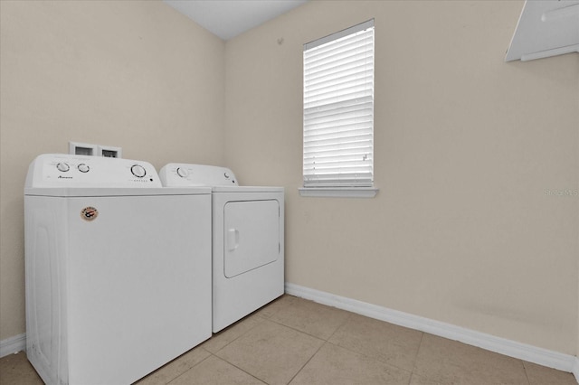 washroom featuring independent washer and dryer and light tile patterned flooring