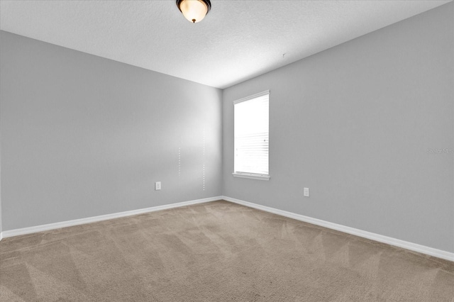 carpeted spare room with a textured ceiling