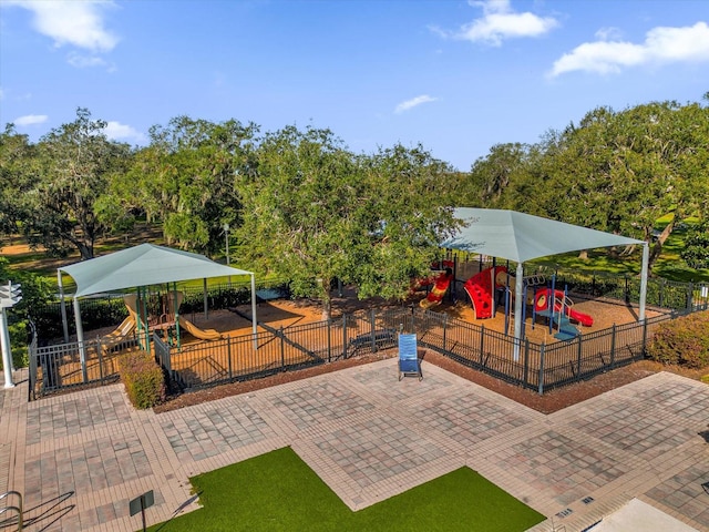 exterior space featuring playground community and fence