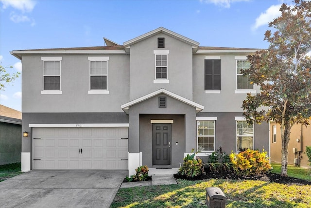 view of front of property with a garage, driveway, and stucco siding