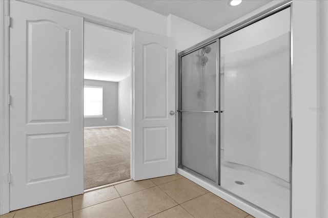 full bathroom featuring an enclosed shower and tile patterned flooring