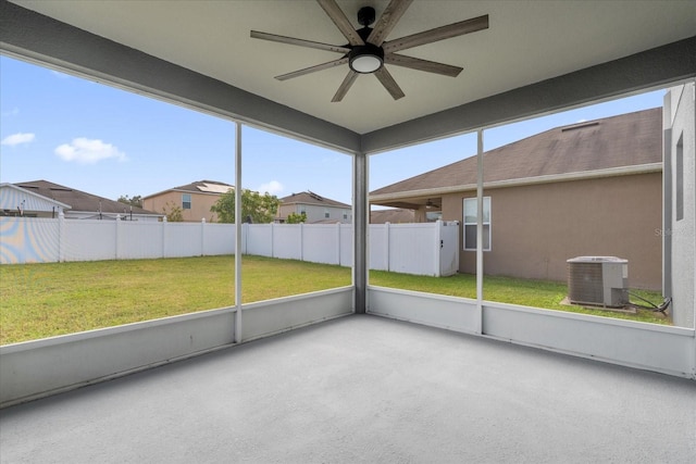 unfurnished sunroom featuring ceiling fan