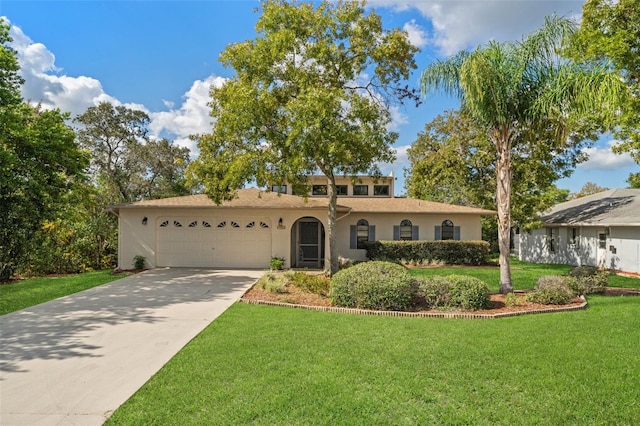 view of front of property with a garage and a front yard