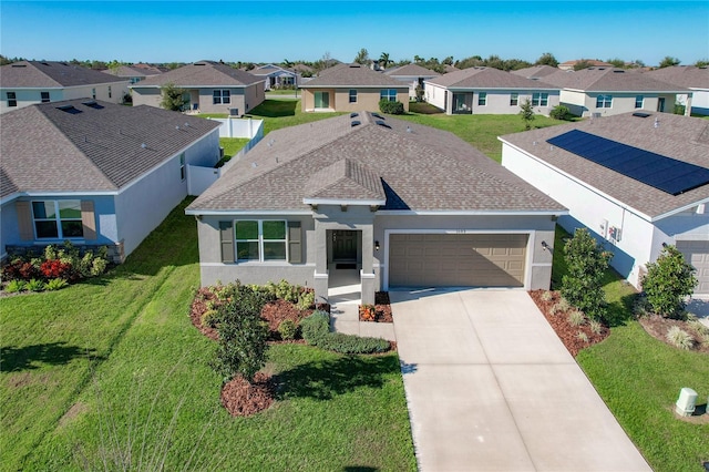 ranch-style home featuring a front lawn and a garage