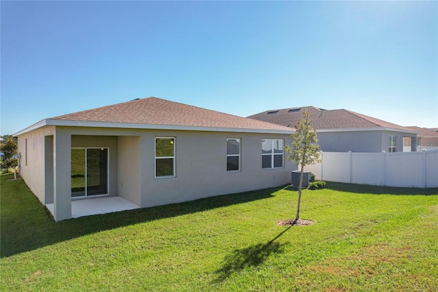 back of house featuring a yard and a patio