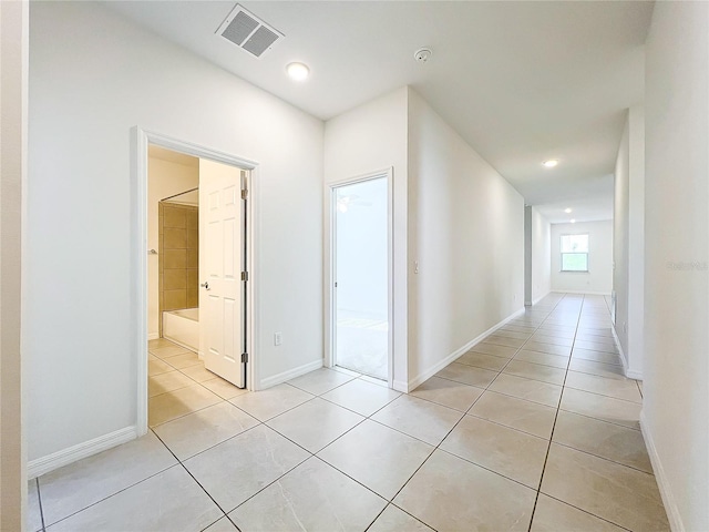 hall with light tile patterned floors