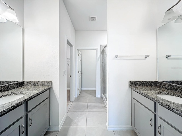 bathroom with tile patterned floors, vanity, and a shower with shower door