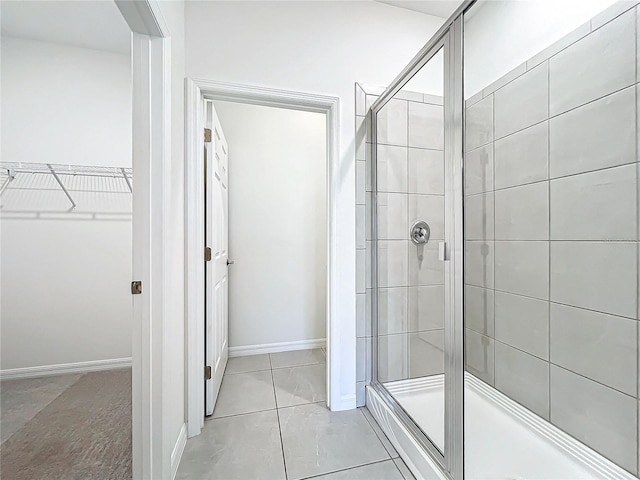 bathroom with tile patterned floors and walk in shower