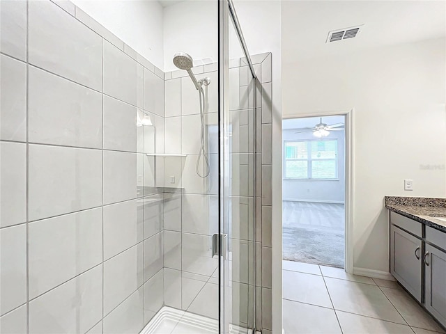 bathroom featuring ceiling fan, tile patterned flooring, vanity, and an enclosed shower