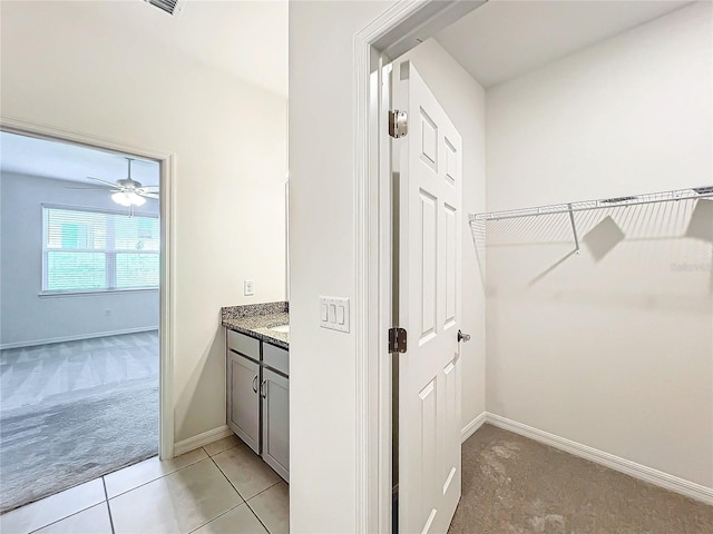 bathroom featuring vanity, tile patterned floors, and ceiling fan