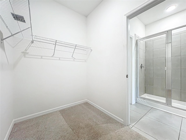 spacious closet with light tile patterned floors