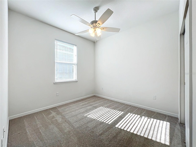 empty room featuring carpet flooring and ceiling fan