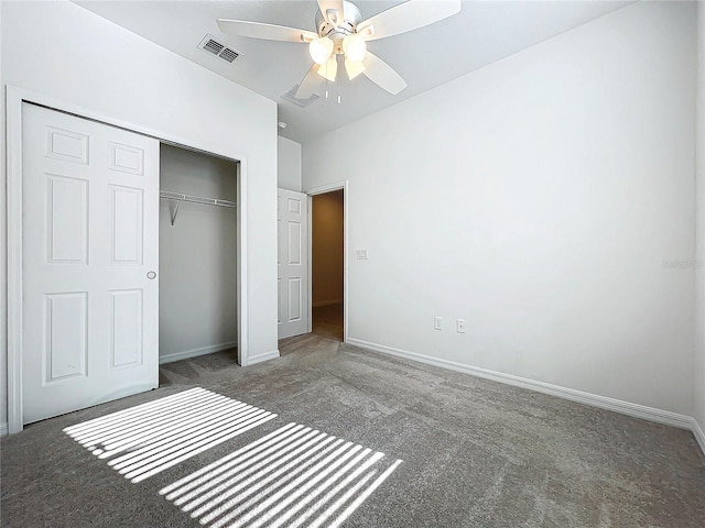 unfurnished bedroom featuring dark colored carpet, ceiling fan, and a closet