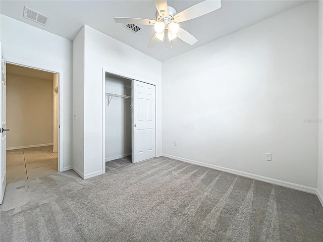 unfurnished bedroom featuring carpet, ceiling fan, and a closet