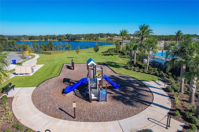 view of jungle gym featuring a lawn and a water view