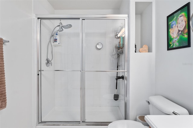 bathroom featuring toilet and walk in shower