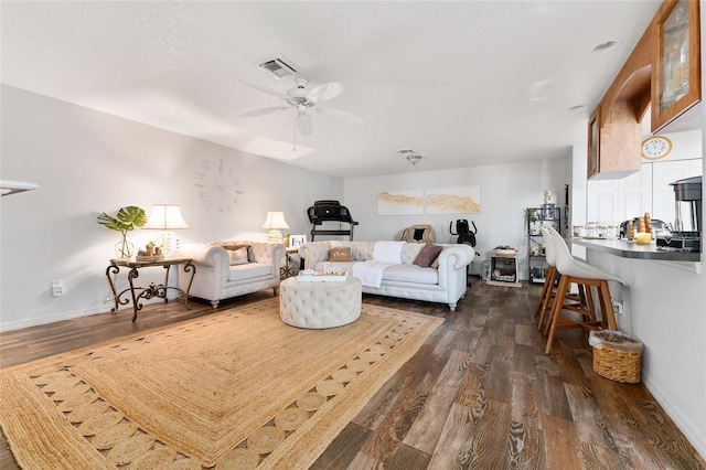 living room with ceiling fan and dark hardwood / wood-style floors