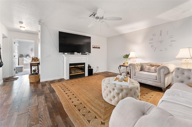 living room with hardwood / wood-style floors, a textured ceiling, and ceiling fan