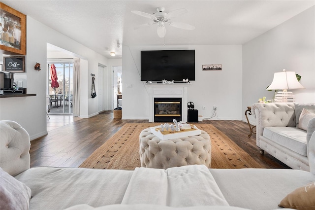 living room featuring ceiling fan and wood-type flooring