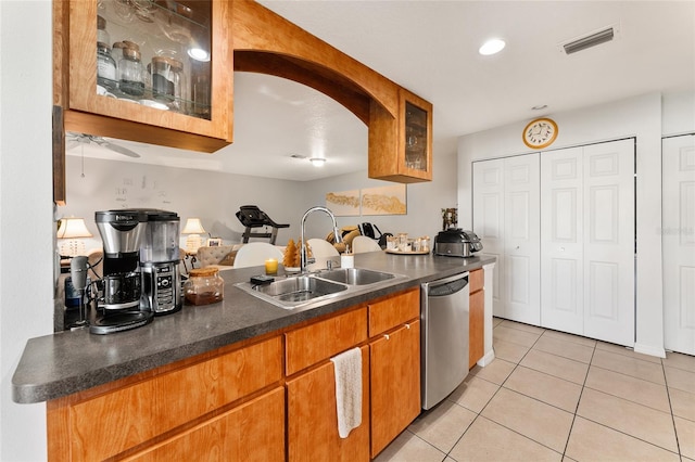 kitchen with dishwasher, sink, and light tile patterned flooring