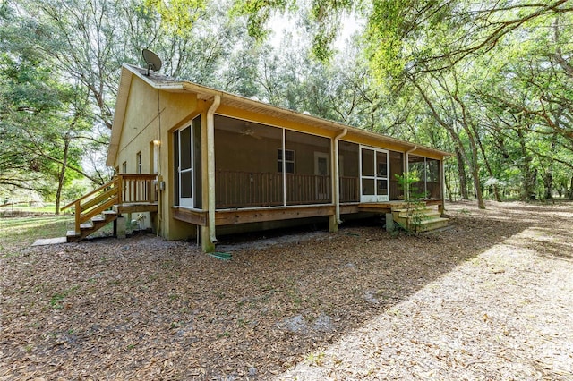 view of side of home with a sunroom