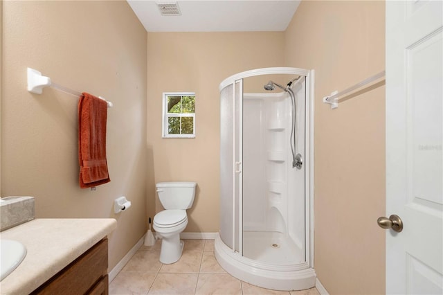 bathroom with tile patterned flooring, vanity, toilet, and a shower with shower door