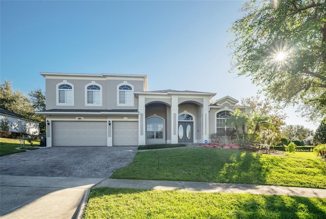 view of front of home with a front yard and a garage