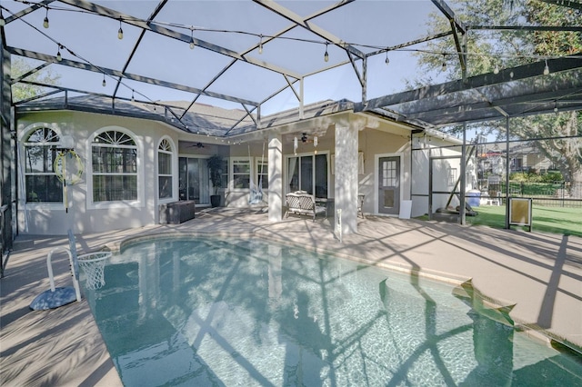 view of pool with pool water feature, a patio area, ceiling fan, and a lanai