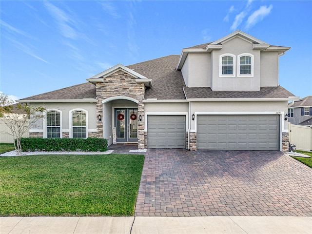 view of front of home with a front lawn and a garage