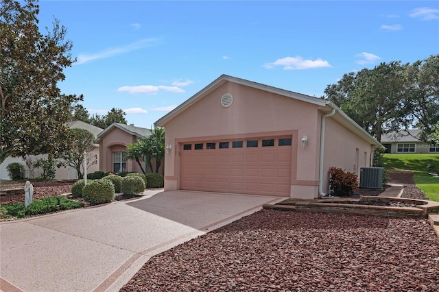 view of front of property with a garage and central air condition unit