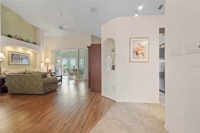 living room featuring light hardwood / wood-style flooring and ceiling fan