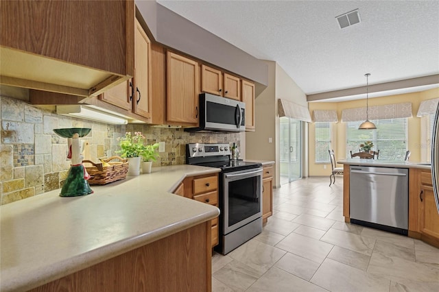 kitchen featuring appliances with stainless steel finishes, backsplash, a textured ceiling, hanging light fixtures, and lofted ceiling