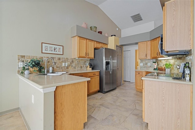 kitchen featuring high vaulted ceiling, sink, tasteful backsplash, kitchen peninsula, and stainless steel appliances