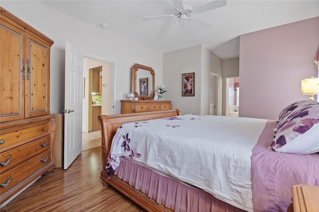 bedroom with ceiling fan, ensuite bath, and light hardwood / wood-style flooring