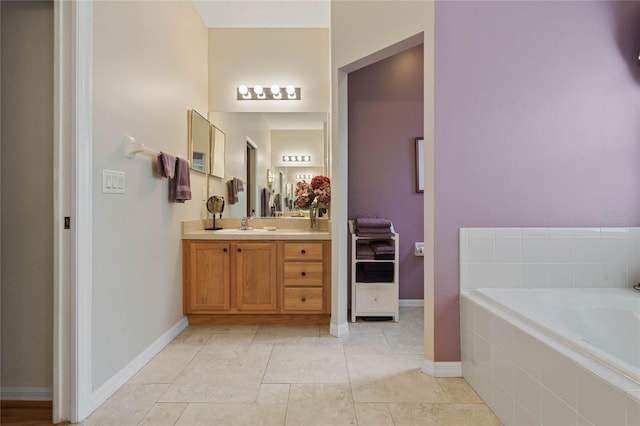 bathroom with tile patterned floors, vanity, and tiled tub