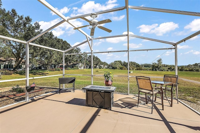 view of patio / terrace featuring glass enclosure and ceiling fan